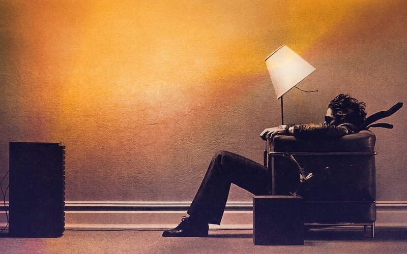 man sitting in chair with lamp