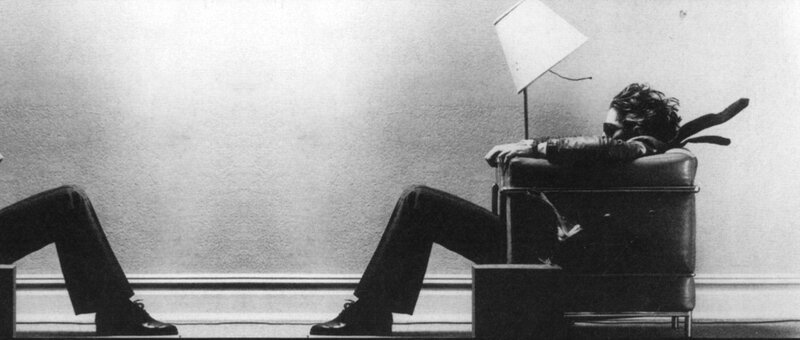 man sitting in chair with lamp