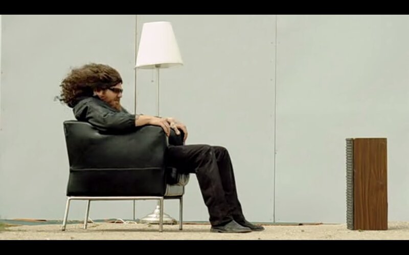 man sitting in chair with lamp
