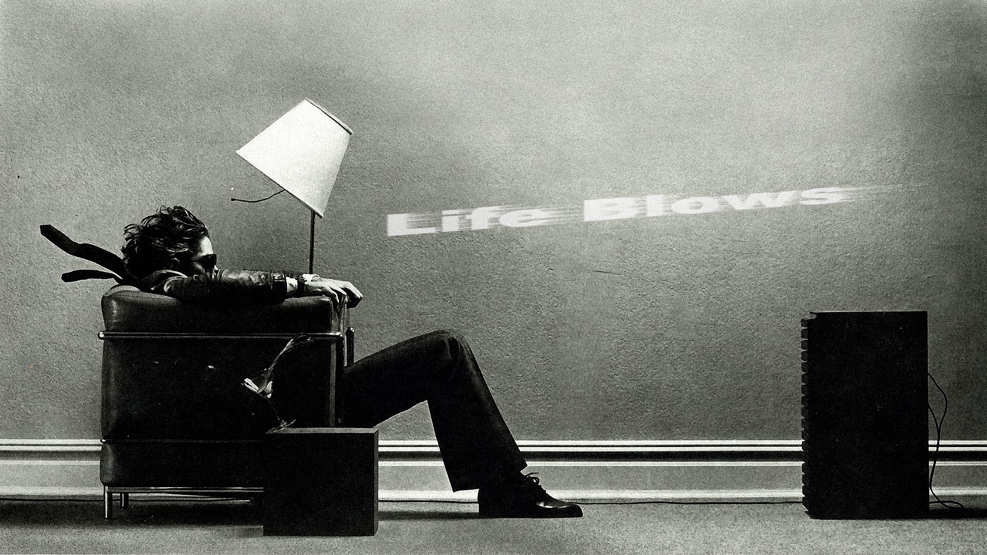 Man sitting in chair with text