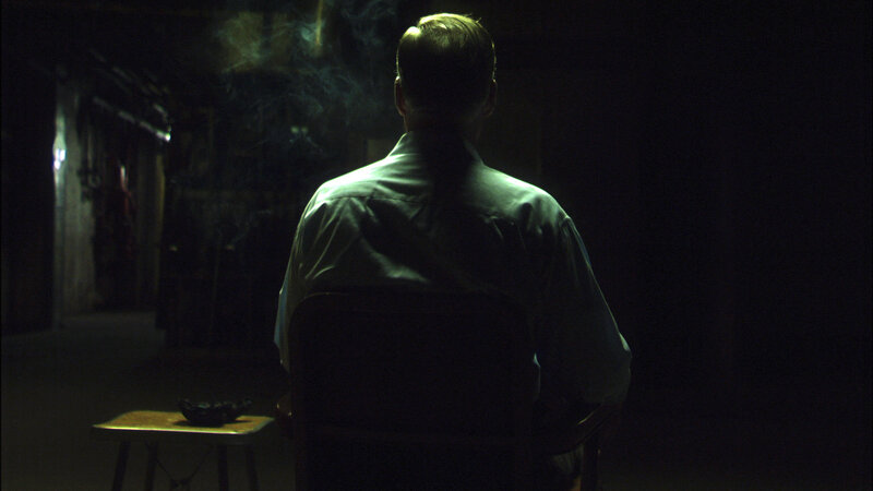 man sitting in dark room