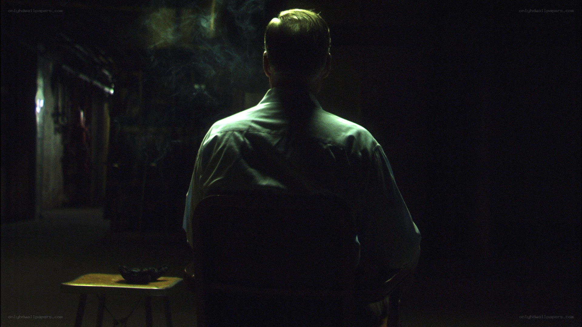 man sitting in dark room