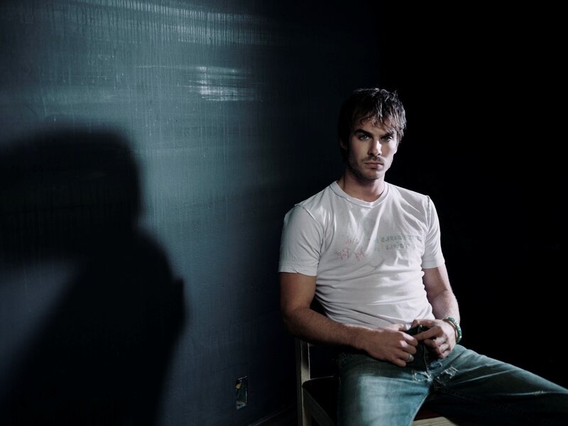 man sitting in dim light
