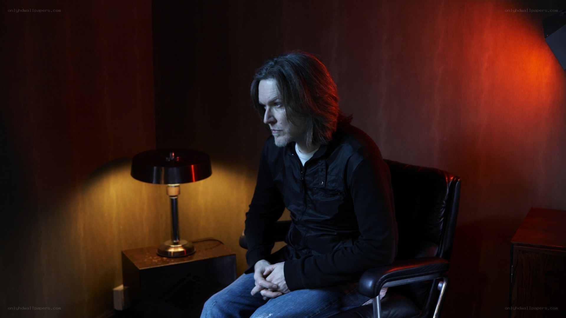 man sitting in dimly lit room