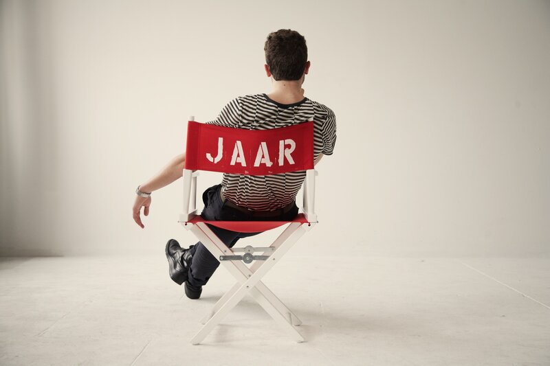 Man sitting in director's chair