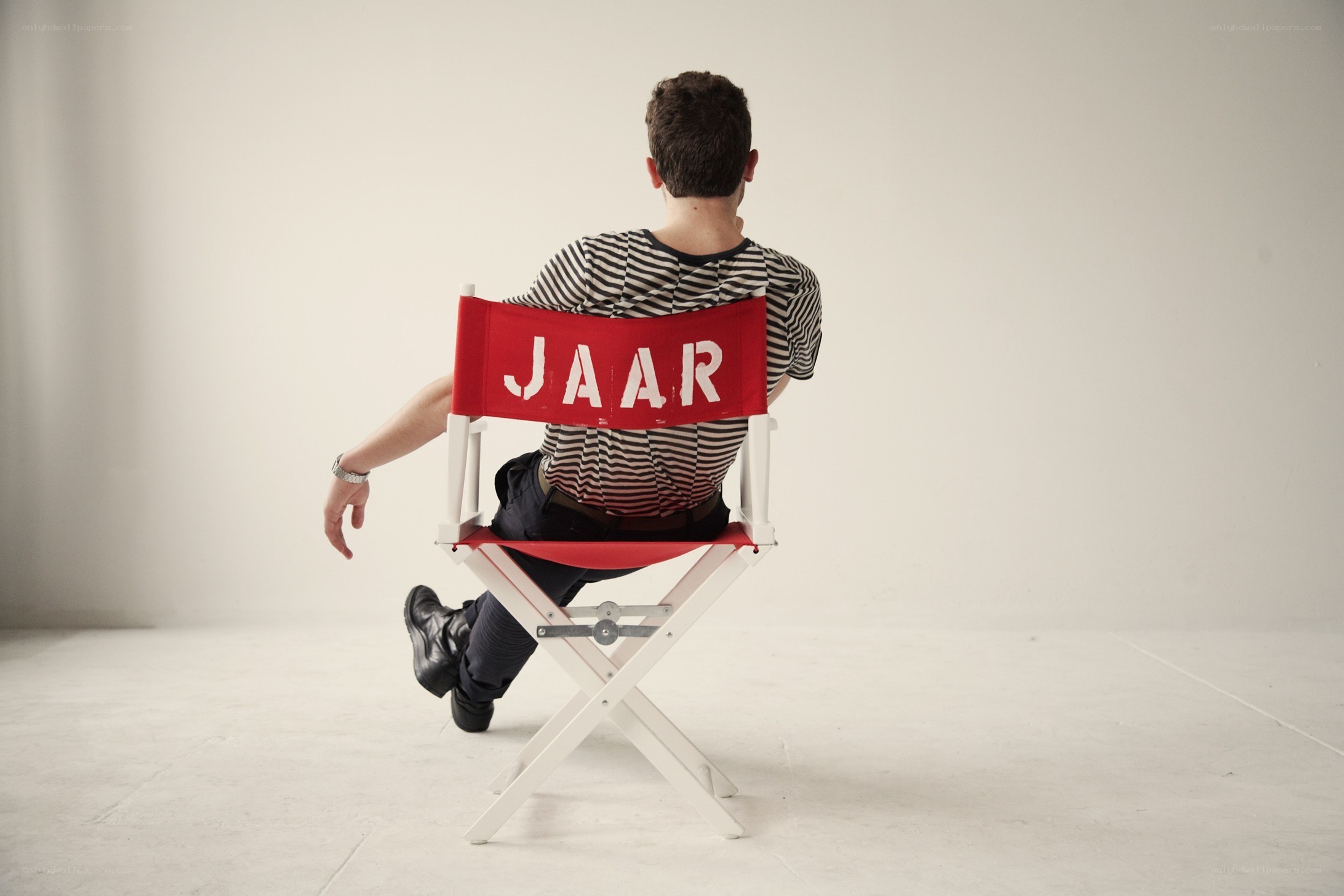 Man sitting in director's chair