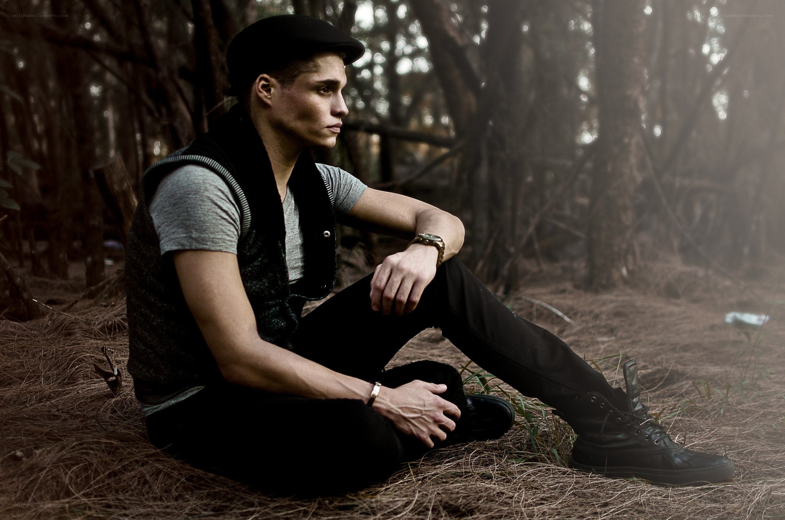 man sitting in forest
