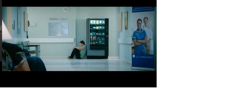 Man Sitting in Hospital Hallway
