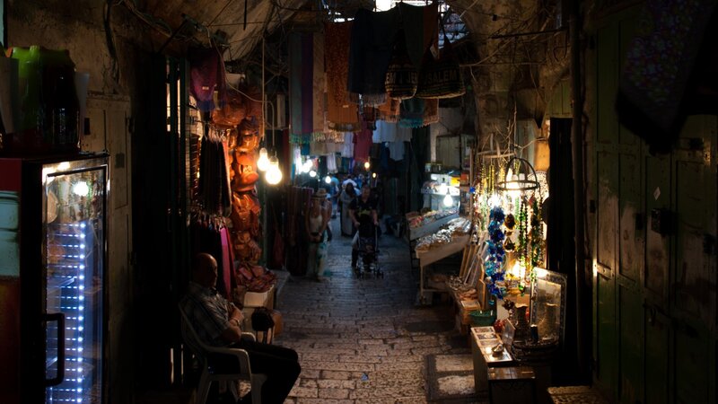 Man Sitting in Market Alley