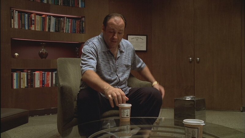 man sitting in office with coffee