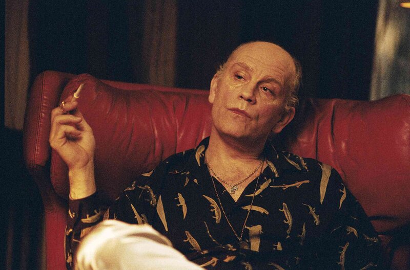 man sitting in red chair