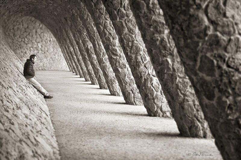 Man sitting in stone tunnel