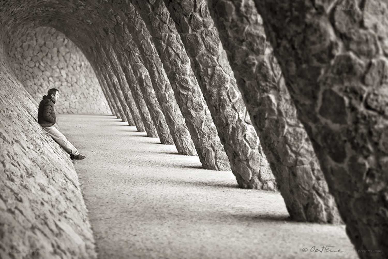 Man sitting in stone tunnel