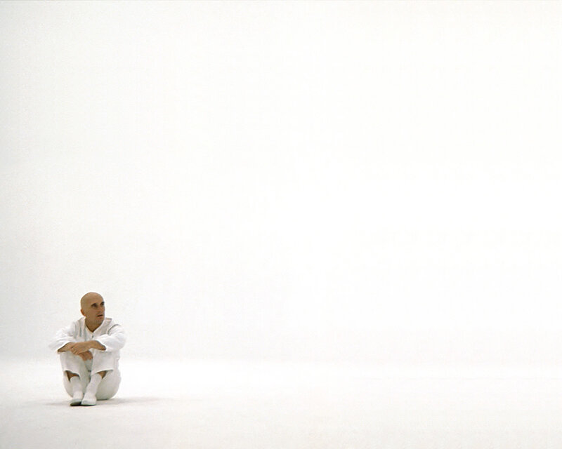 man sitting in white room
