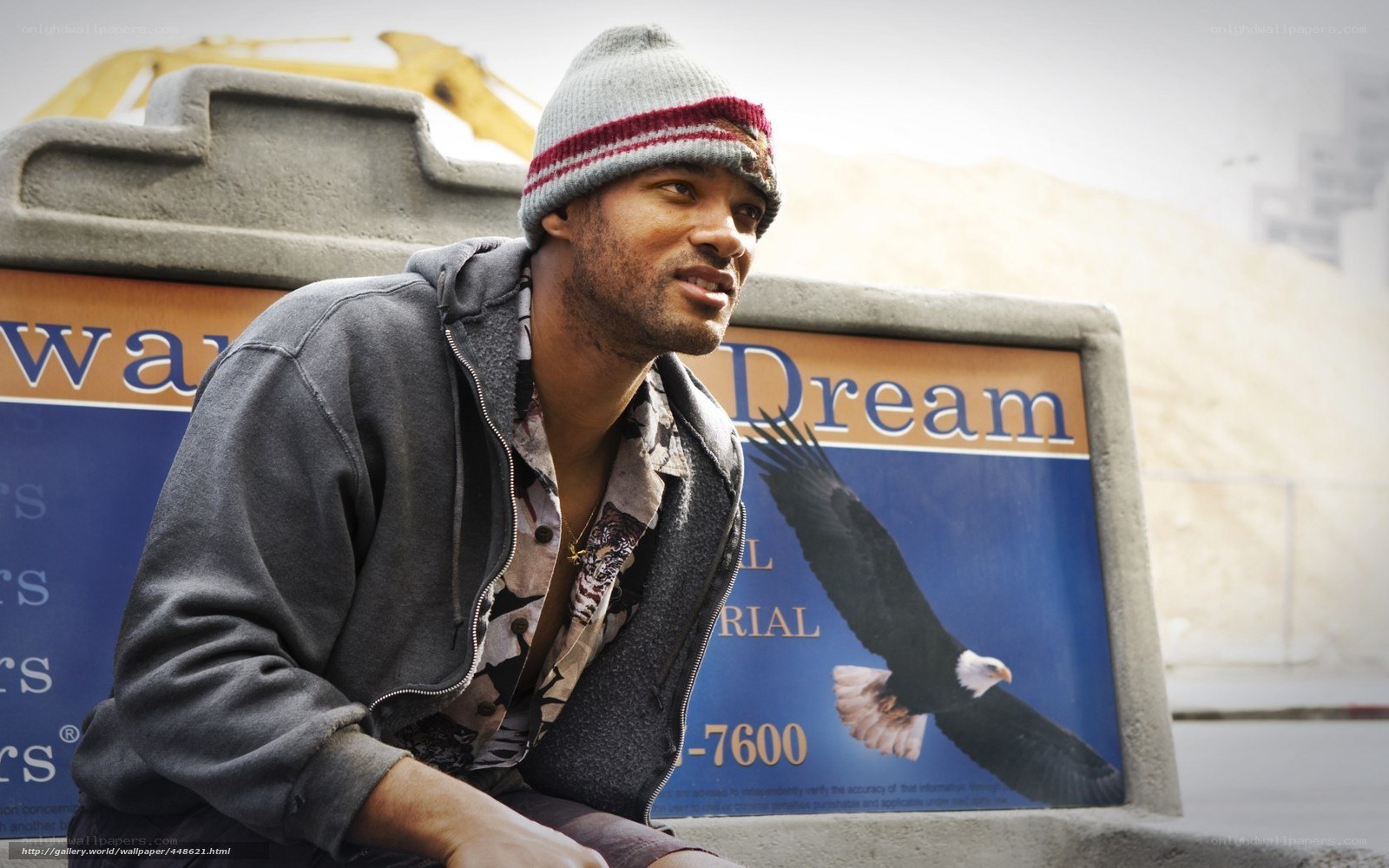 man sitting near dream sign