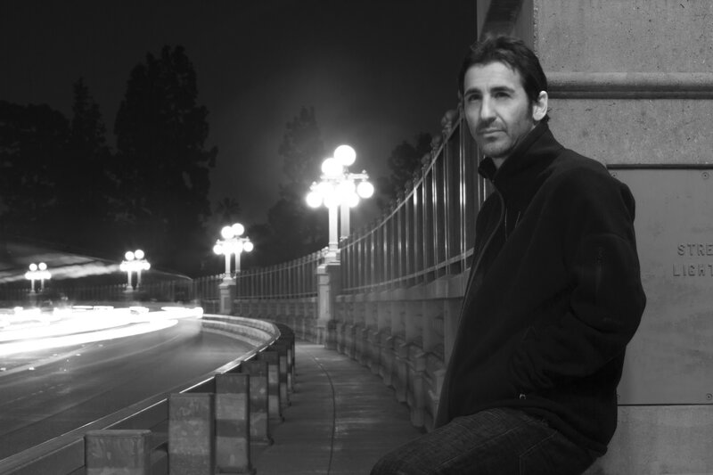 Man Sitting on a Bridge