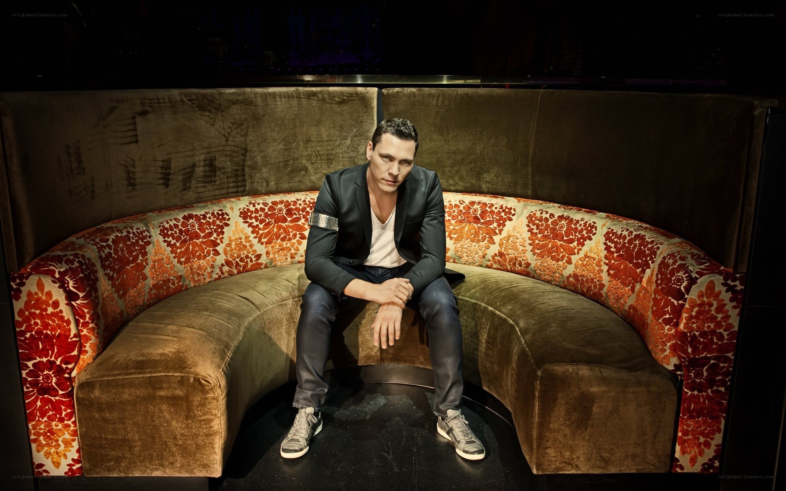 Man sitting on a floral couch