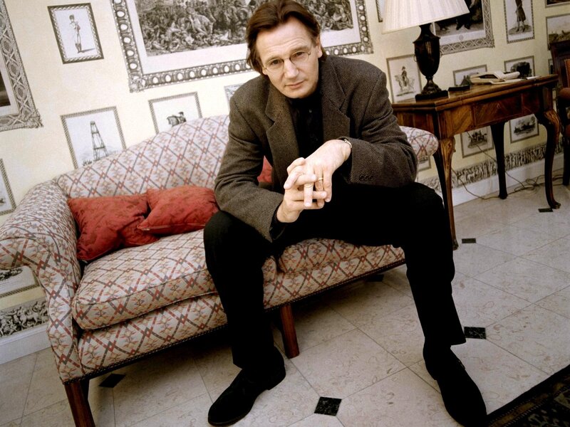 man sitting on a patterned sofa