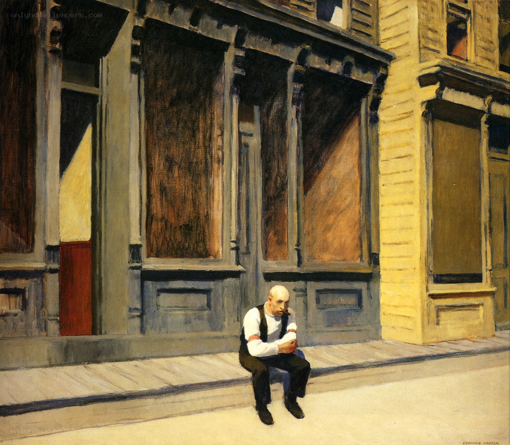 Man sitting on a sidewalk