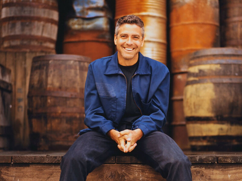 Man Sitting on Barrel