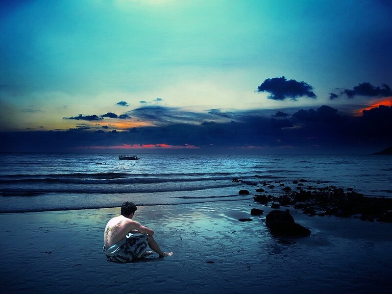 Man Sitting on Beach — Blue