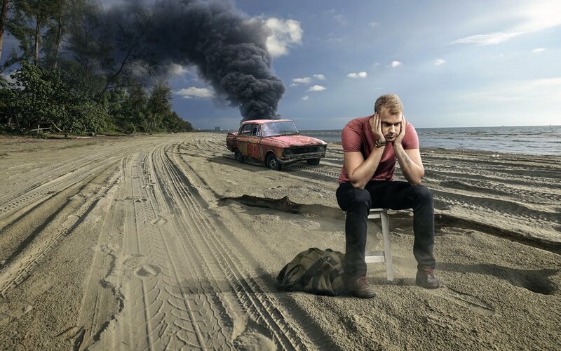 Man Sitting on Beach — Brown, Dramatic