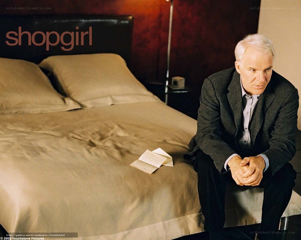 Man sitting on bed with letter