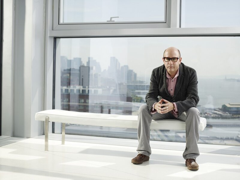 man sitting on bench by window