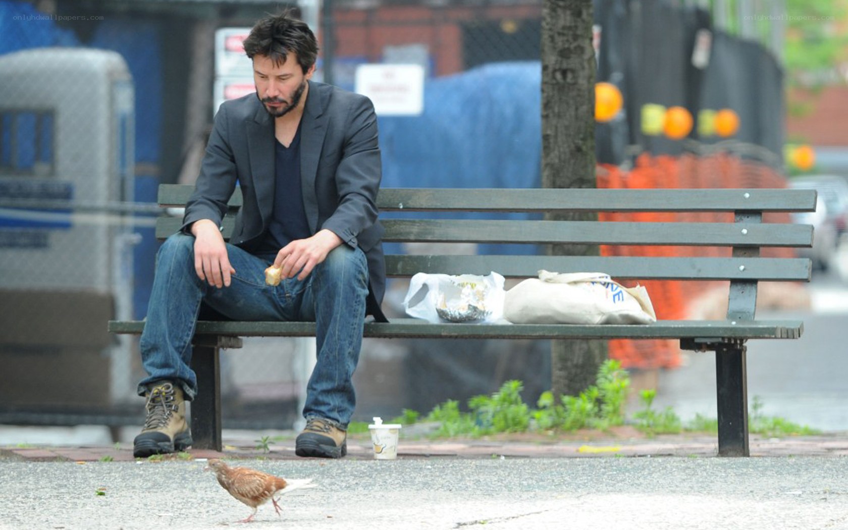 man sitting on bench eating