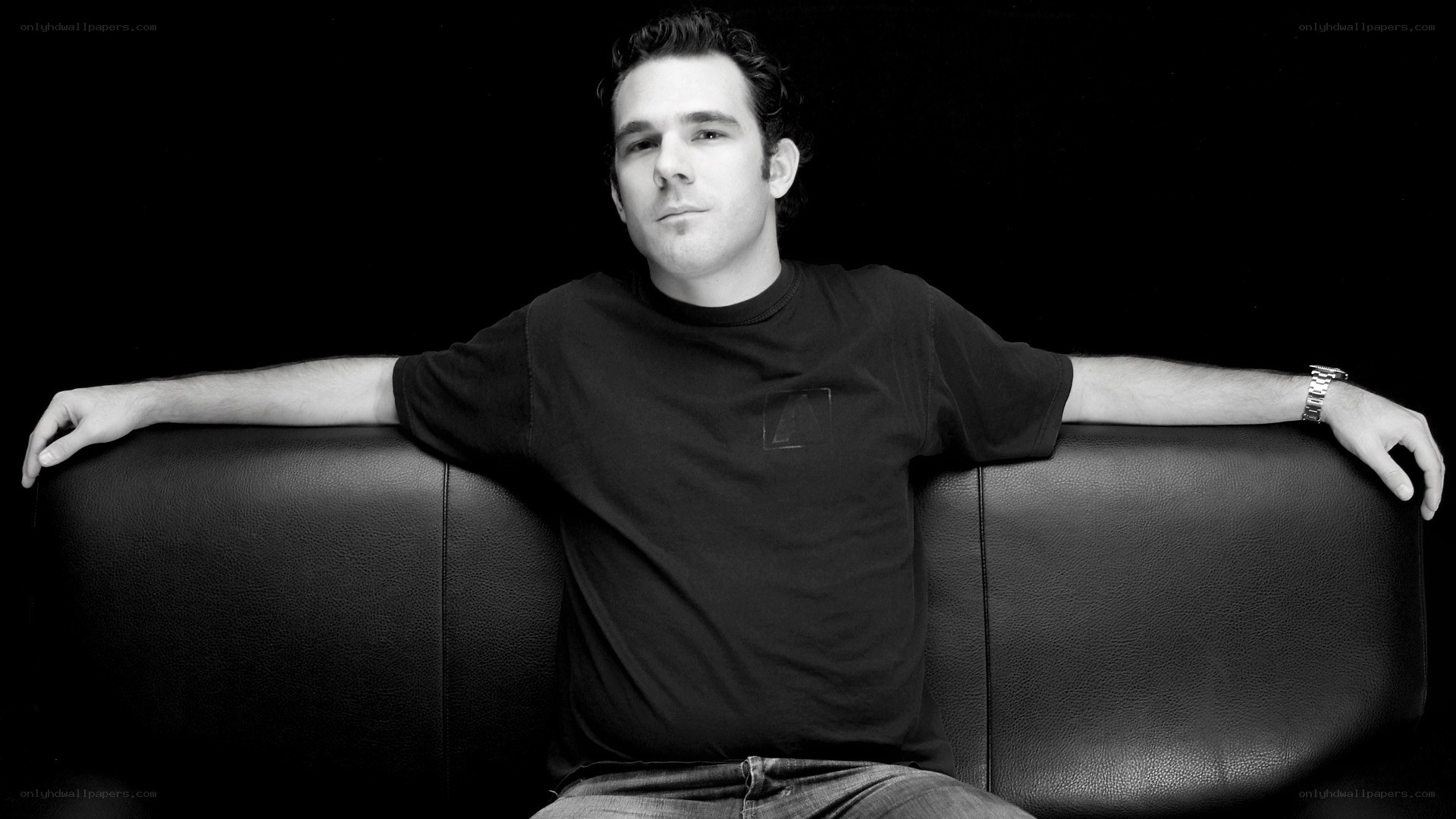 man sitting on black couch