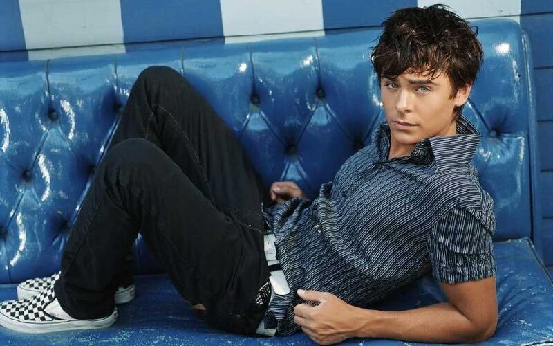 Man Sitting on Blue Couch