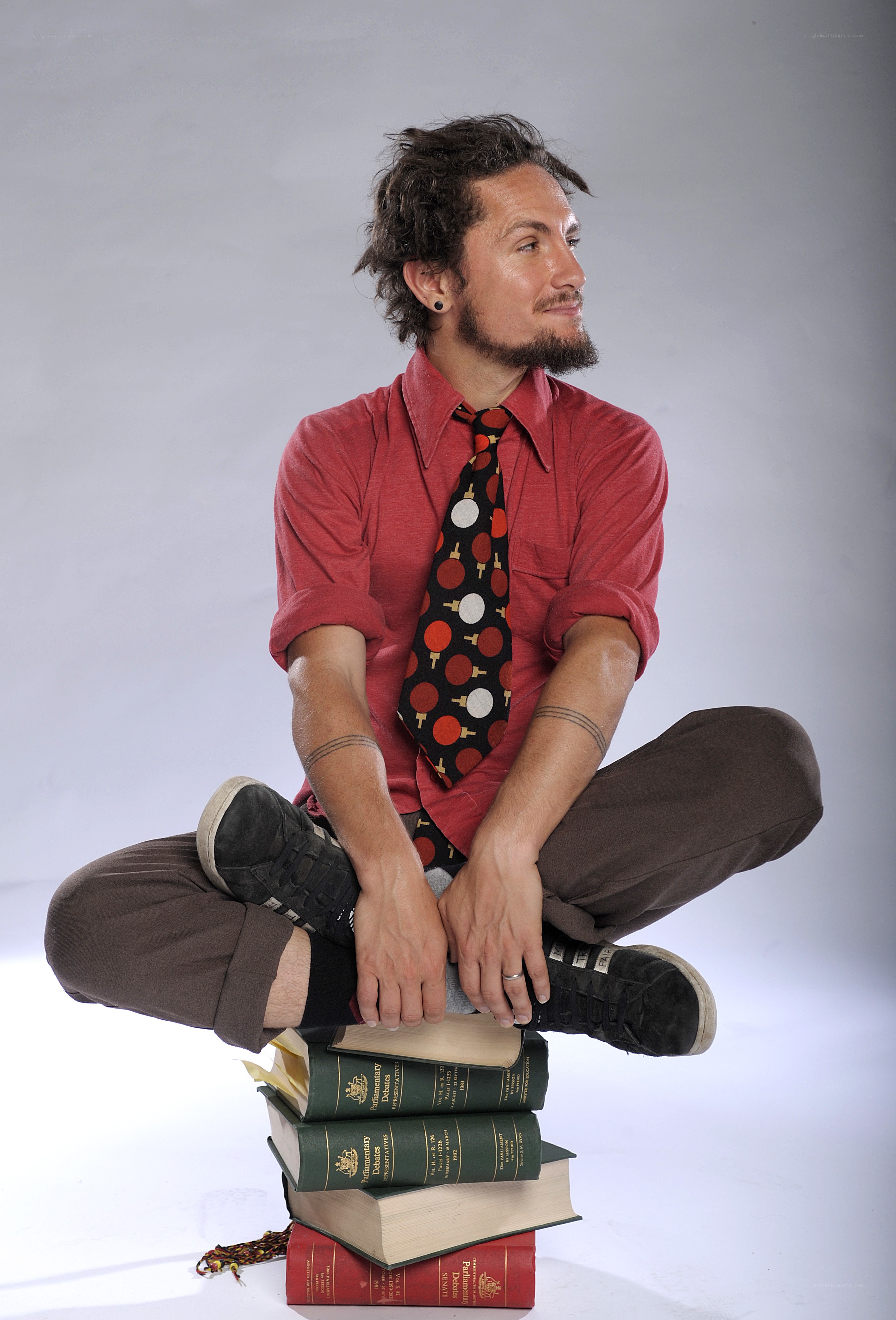 man sitting on books