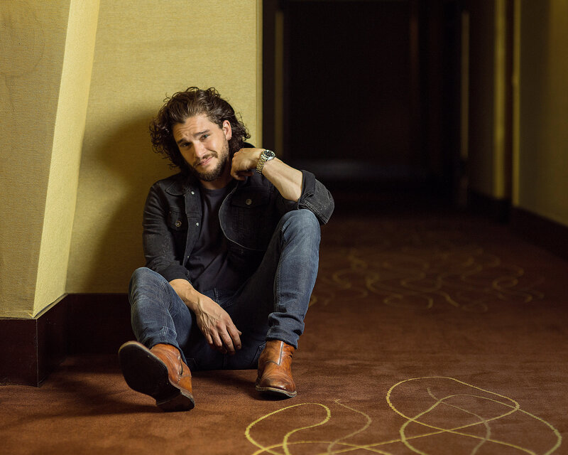 man sitting on carpeted floor