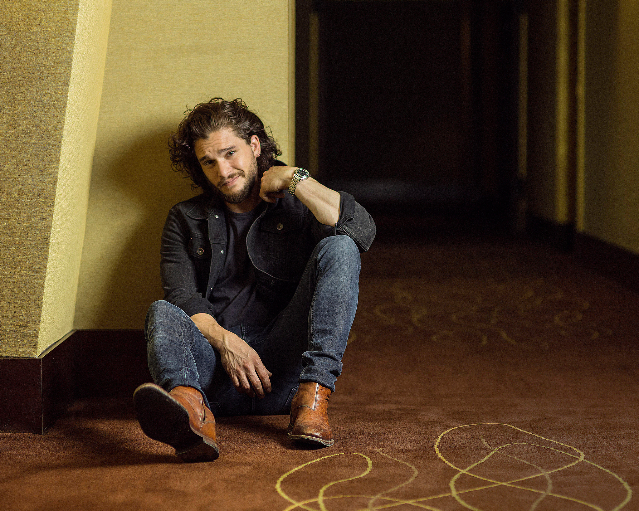 man sitting on carpeted floor
