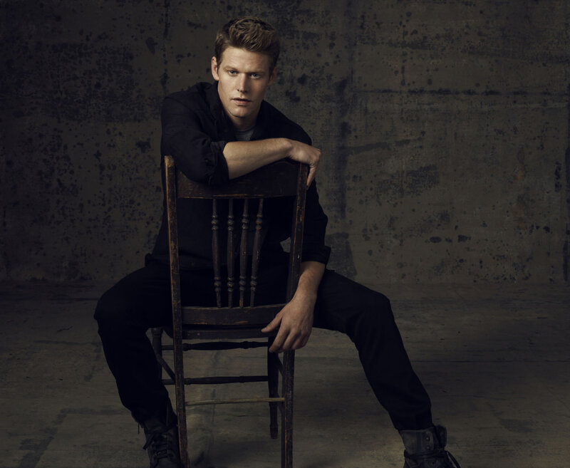 Man Sitting on Chair — Black, Serious