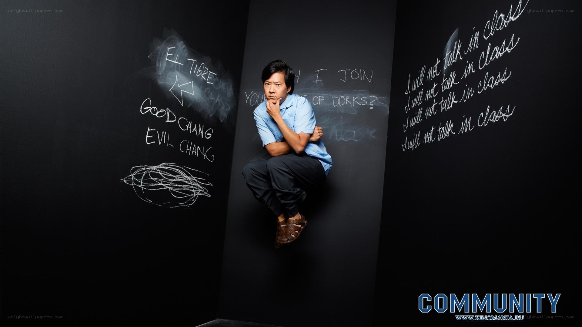 man sitting on chalkboard wall