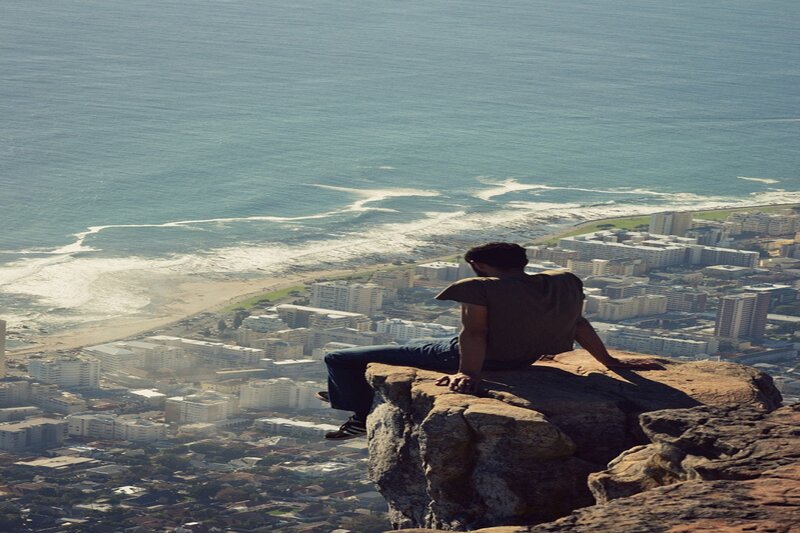 Man Sitting on Cliff — Blue