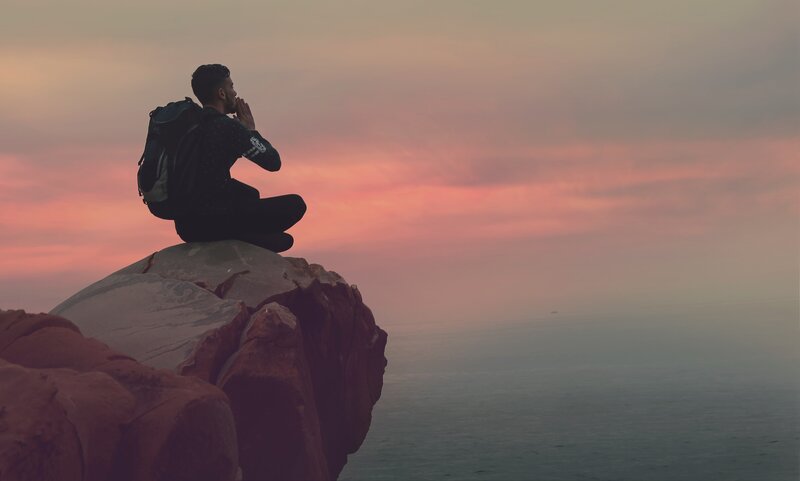 Man Sitting on Cliff — Pink
