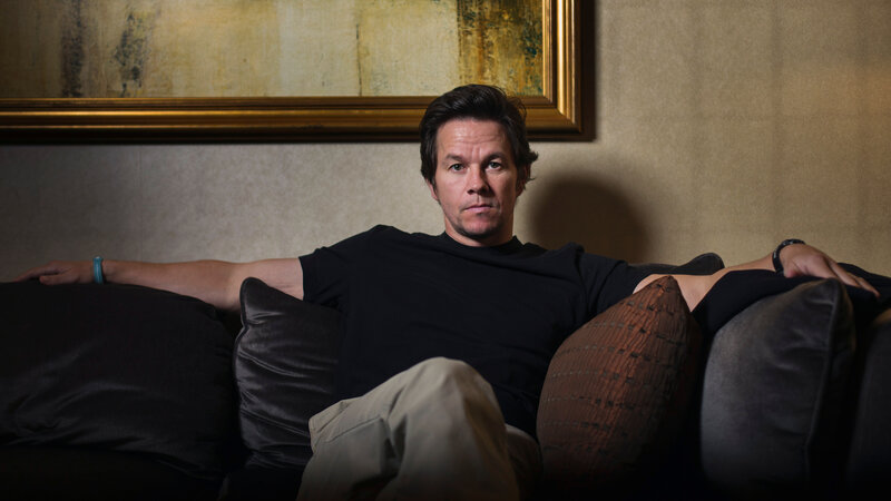 Man Sitting on Couch — Black, Serious, Photograph, Pillows