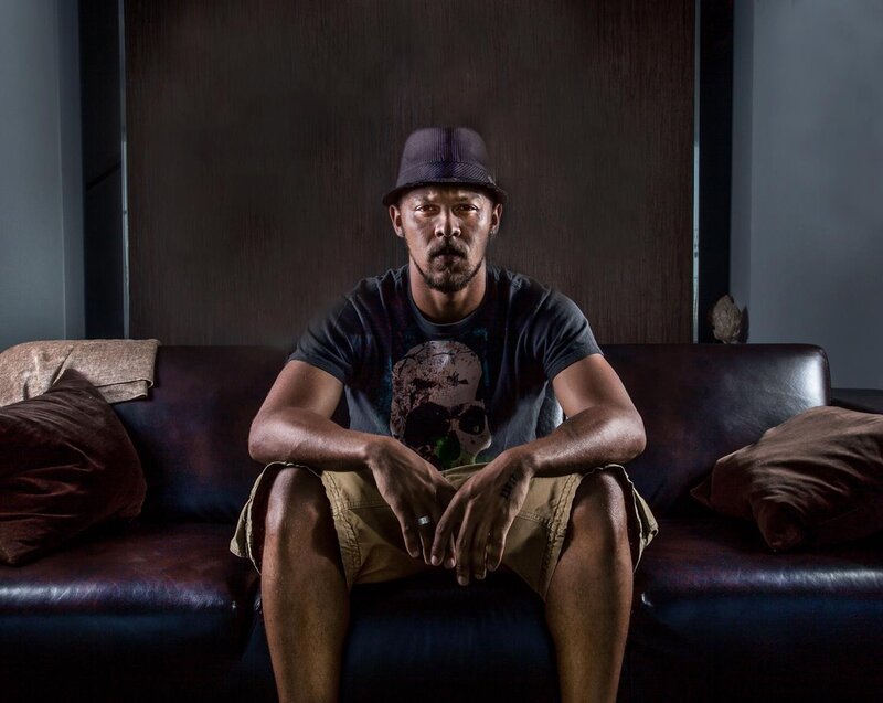 Man Sitting on Couch — Brown, Serious