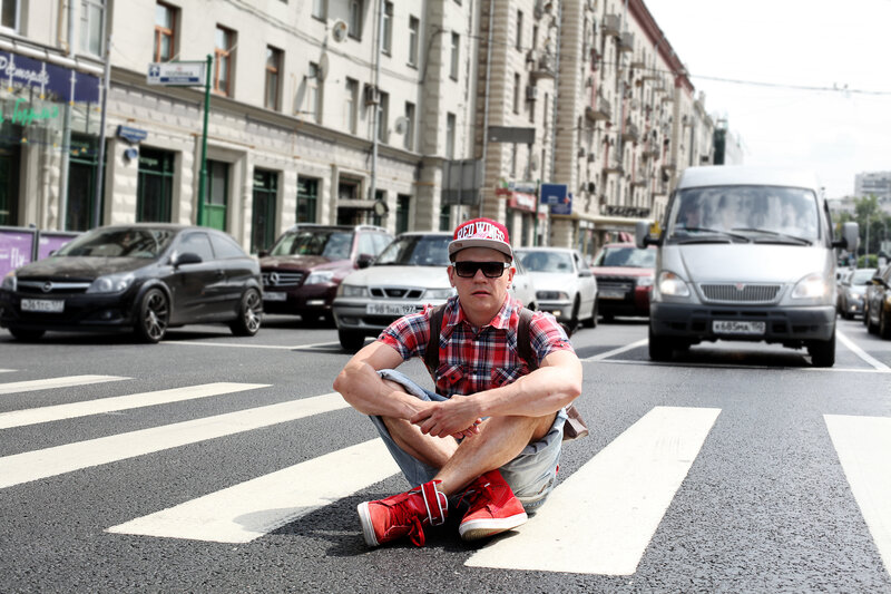Man sitting on crosswalk