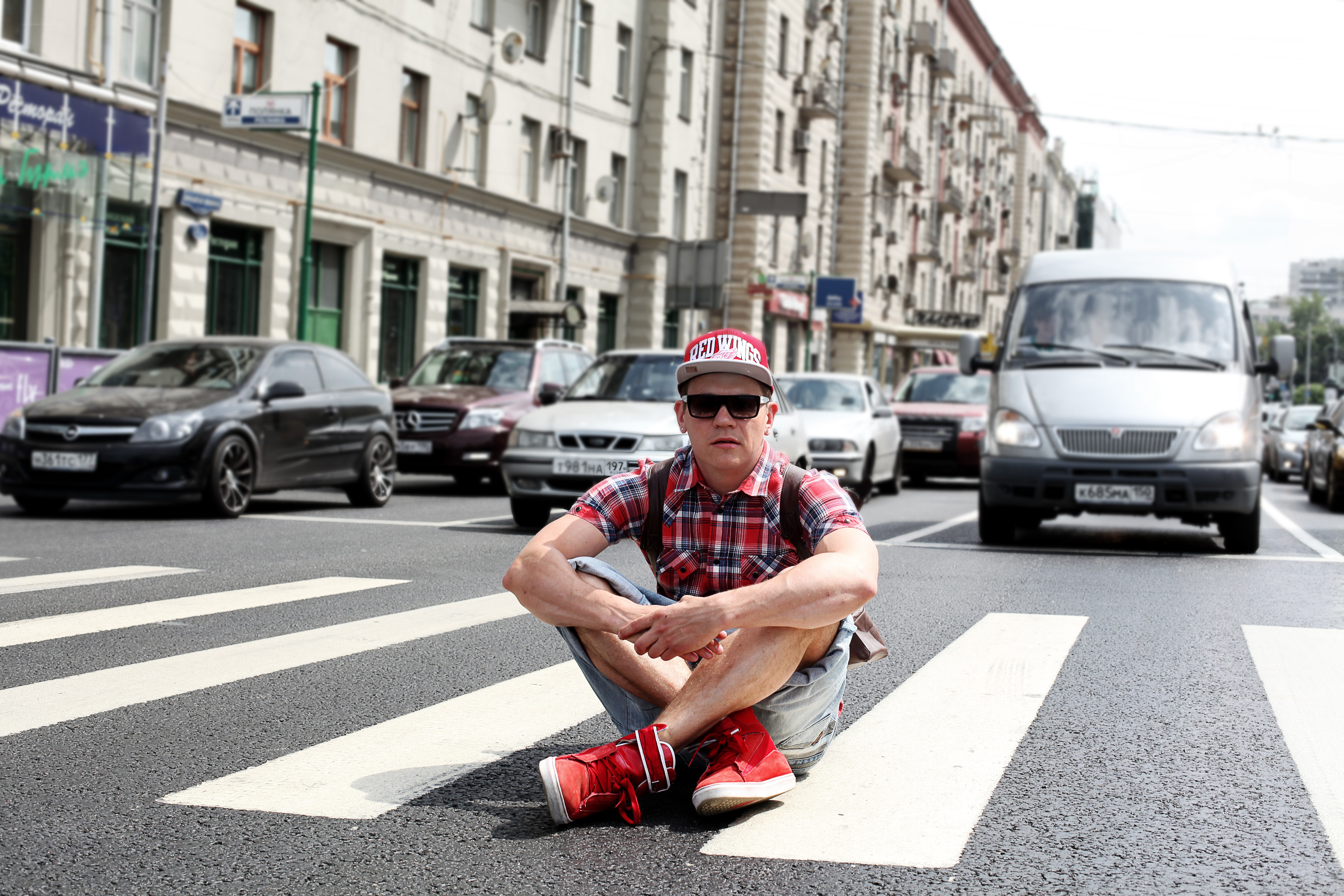 Man sitting on crosswalk