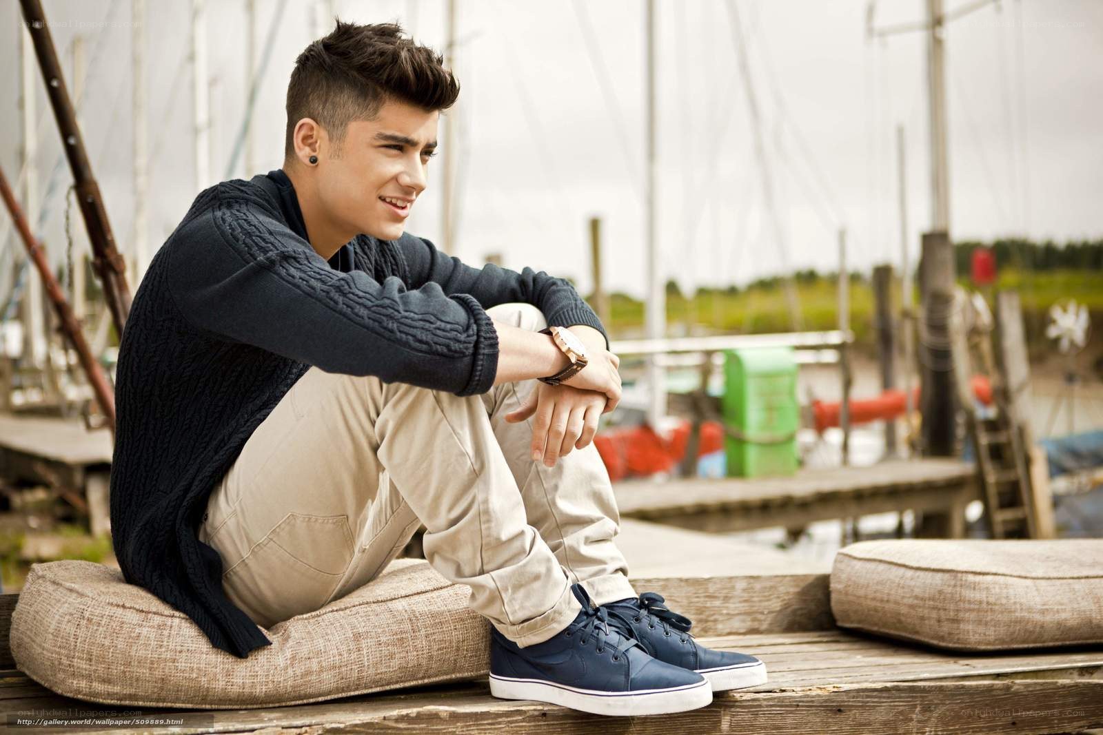 man sitting on dock