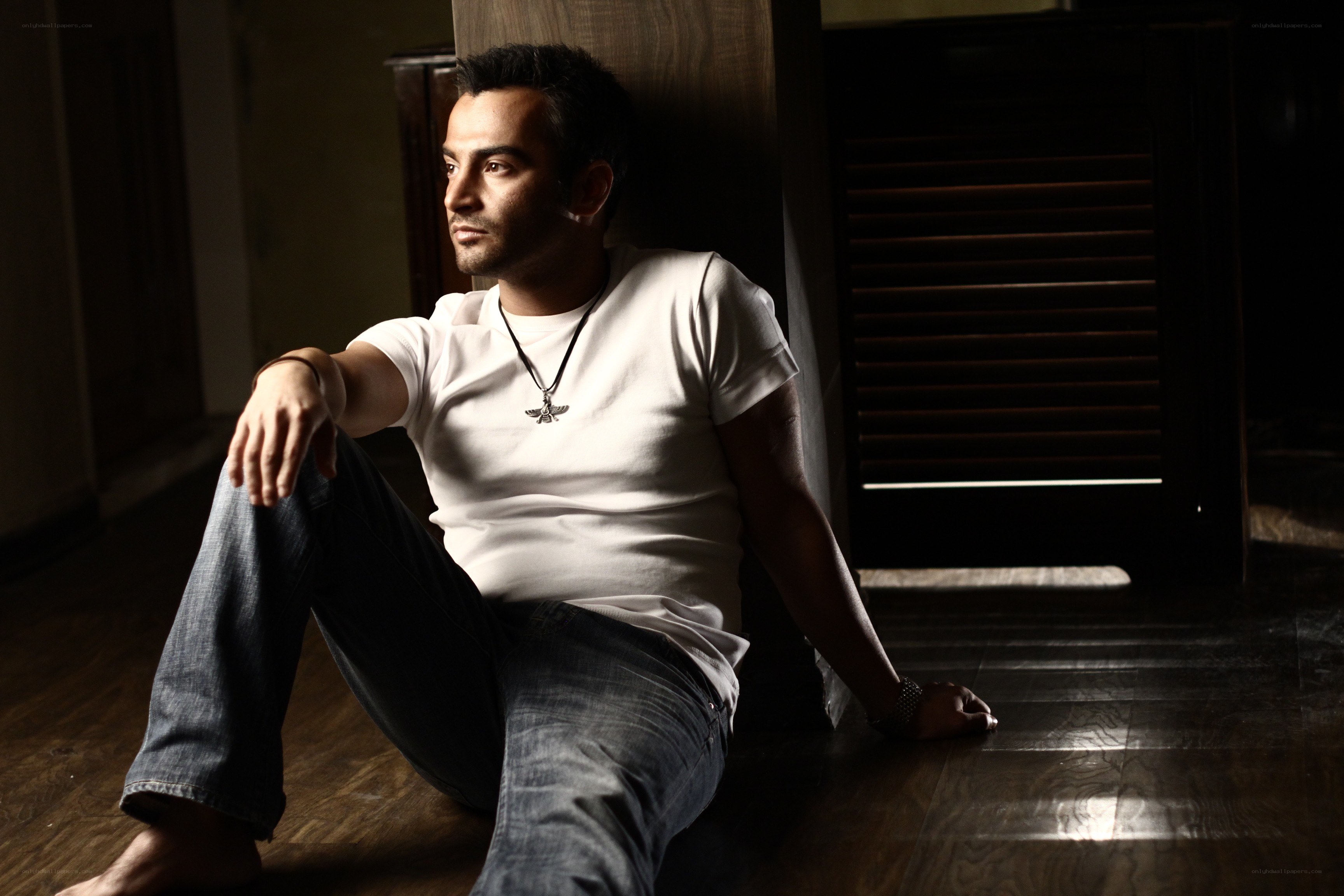 man sitting on floor in dim light