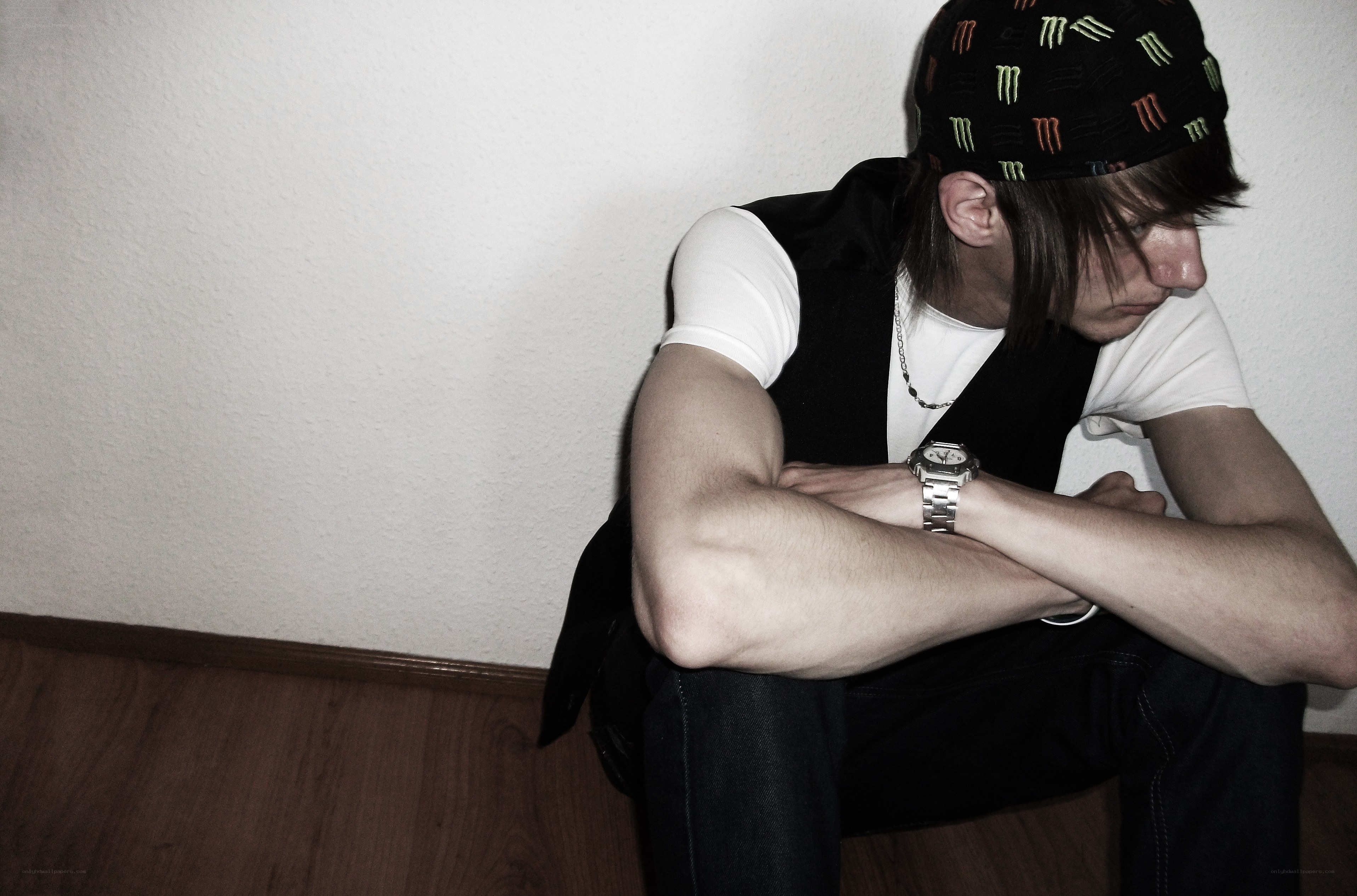 man sitting on floor with arms crossed