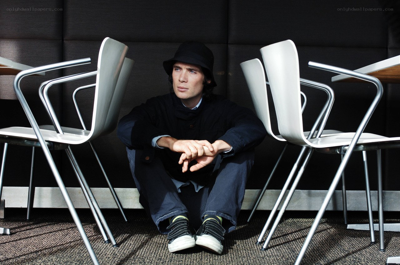 man sitting on floor with chairs
