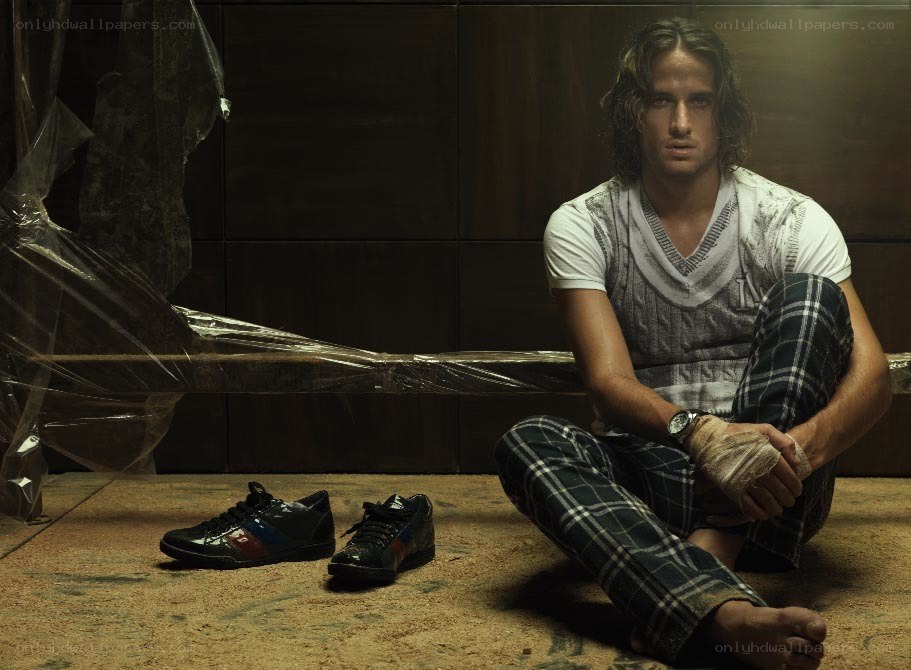 man sitting on floor with shoes