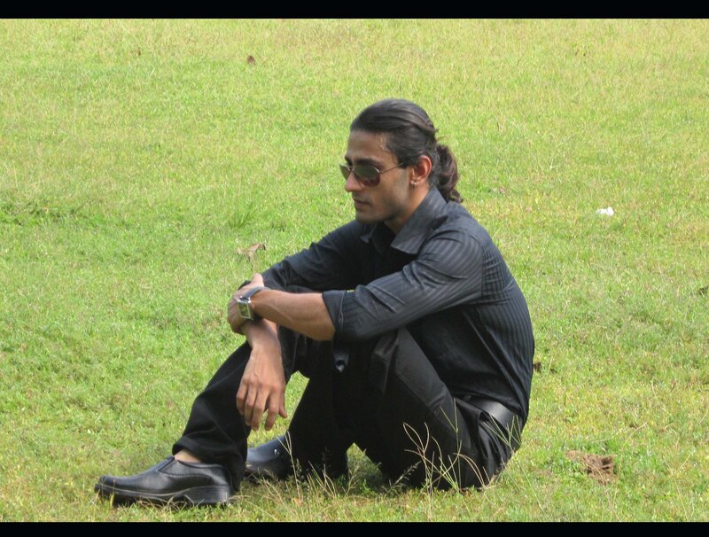 Man Sitting on Grass — Green