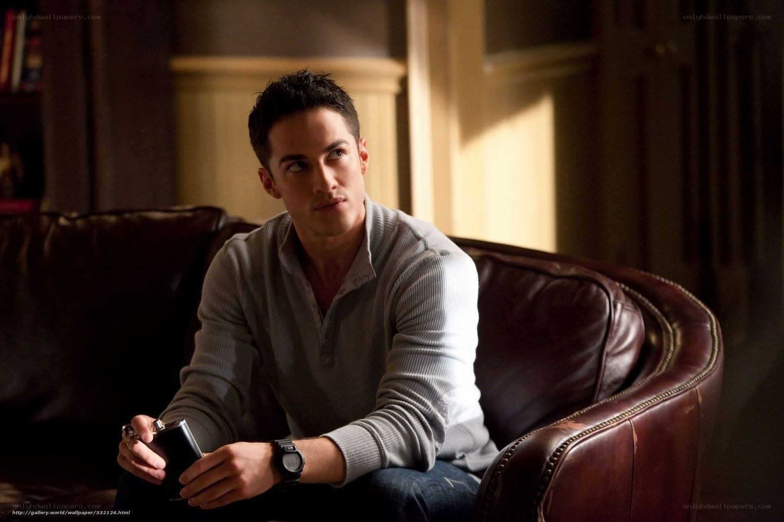 man sitting on leather couch