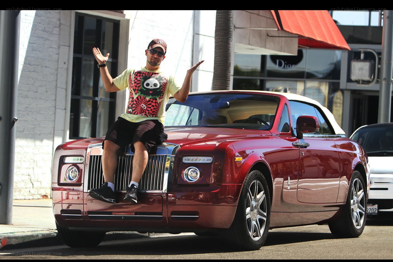 Man sitting on luxury car